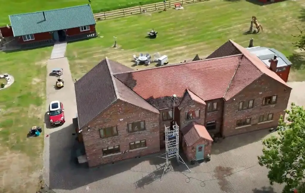large house during roof cleaning process