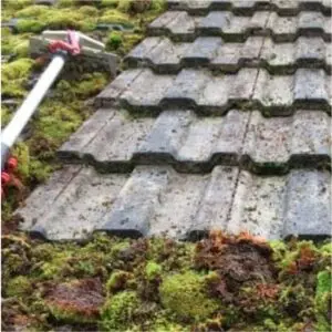 roof scrapiong during moss removal procedure