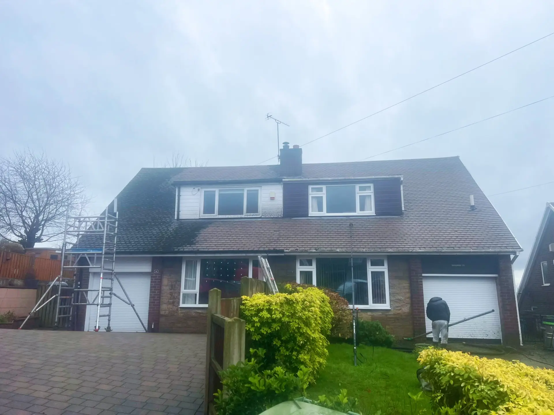 Moss removal service - roof half way done