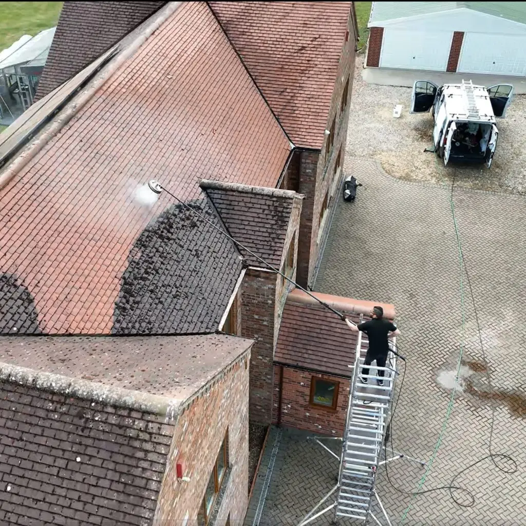 Proper setup with scaffold and roof cleaning procedure in action